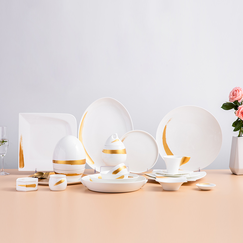 White porcelain dinner set with gold rim