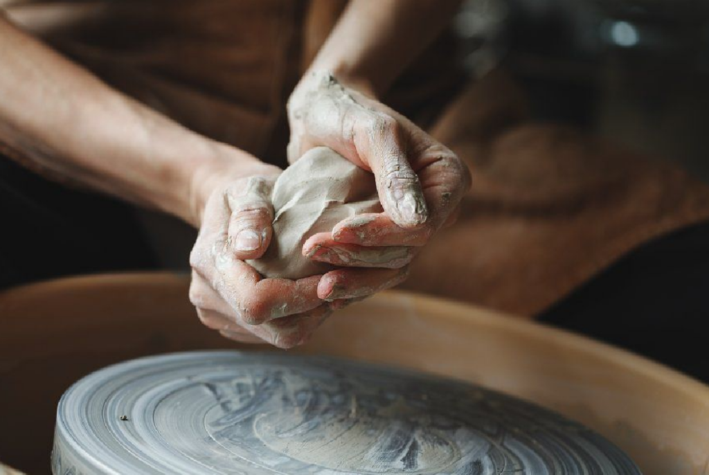 a hand holding a clay